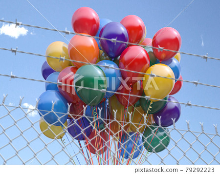 Balloons bunch behind the barbed fence. Freedom or prohibition of celebration concept. Balloons bunch behind the barbed fence. Freedom or prohibition of celebration concept. 79292223