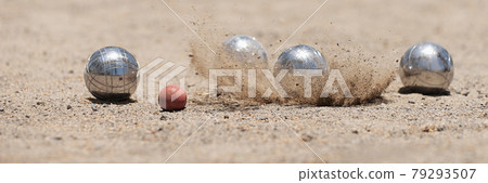 Petanque ball boules bowls on a dust floor, photo in impact. Balls and a small wood jack Petanque ball boules bowls on a dust floor, photo in impact. Balls and a small wood jack 79293507