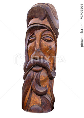 wooden idol statue of koryak on a white background. Selective focus 79295394