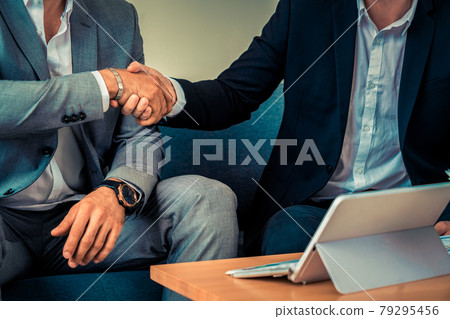 Businessmen handshake business deal in office. Businessmen handshake business deal in office. 79295456