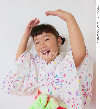 A child in a yukata dancing a Bon festival dance A child in a yukata dancing a Bon festival dance 79295620