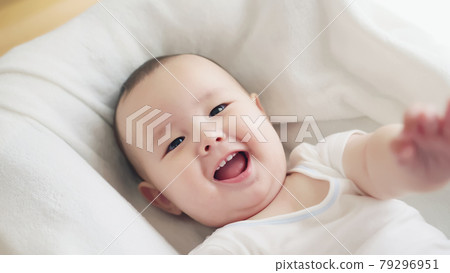 Baby sleeping in crib 79296951