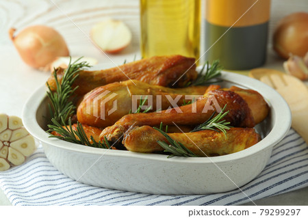 Concept of delicious eating with baking tray with roast chicken drumsticks Concept of delicious eating with baking tray with roast chicken drumsticks 79299297