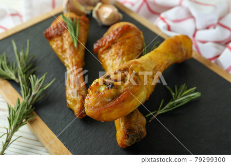 Board with roast chicken drumsticks, close up Board with roast chicken drumsticks, close up 79299300