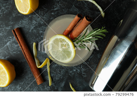 Glass of lemonade with cinnamon and rosemary on black smokey table Glass of lemonade with cinnamon and rosemary on black smokey table 79299476