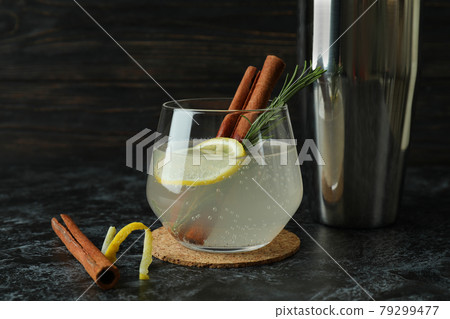 Glass of lemonade with cinnamon and rosemary on black smokey table Glass of lemonade with cinnamon and rosemary on black smokey table 79299477