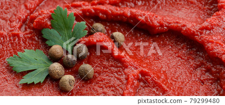 Tomato paste with peppercorn and parsley on whole background Tomato paste with peppercorn and parsley on whole background 79299480