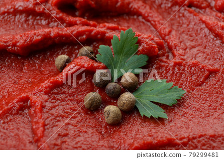 Tomato paste with peppercorn and parsley on whole background 79299481