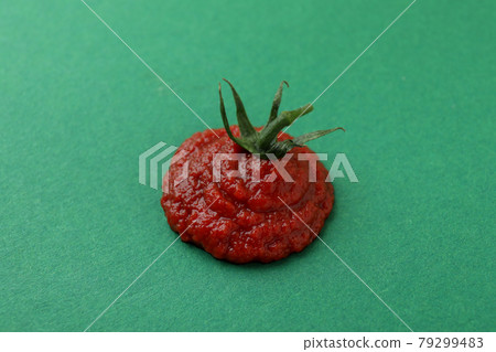Fresh tomato paste on green background, close up Fresh tomato paste on green background, close up 79299483
