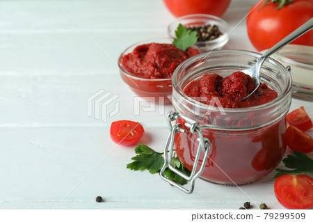 Bowl and jar with tomato paste on white wooden background with ingredients 79299509