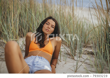 Boho Woman on the Beach near the Sea 79303219