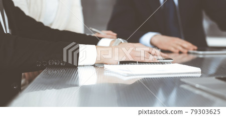 Business people working together at meeting in a modern office. Unknown businessman and woman with colleagues or lawyers at negotiation about contract 79303625