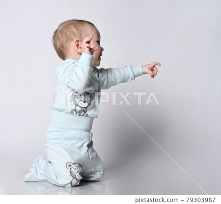 Side view of an adorable little baby baby Toddler 79303987