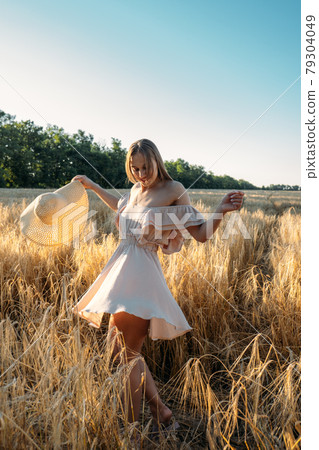 Nature mental health benefits. Connection to Nature, time outside, outdoor day off. Nature deficit disorder. Young woman enjoying nature on wheat field at sunset. Nature mental health benefits. Connection to Nature, time outside, outdoor day off. Nature deficit disorder. Young woman enjoying nature on wheat field at sunset. 79304049