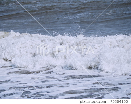White bubbling waves near the shore White bubbling waves near the shore 79304100