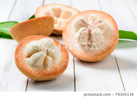 Half Santol on wood background, Santol has sour taste and the middle of santol is sweeter. It is very famous fruit of Lopburi Province. THAILAND 79304136