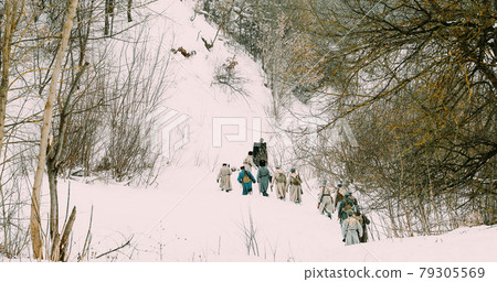 Men Dressed As White Guard Soldiers Of Imperial Russian Army In Russian Civil War Times Marching Through Snowy Winter Forest. Historical Reenactment 1917-1922. 79305569