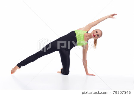 Attractive female gymnast exercising at studio 79307546