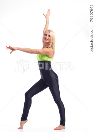 Attractive female gymnast exercising at studio 79307645