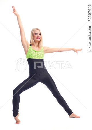 Attractive female gymnast exercising at studio 79307646