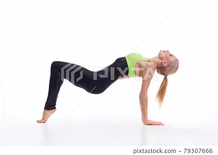 Attractive female gymnast exercising at studio 79307666