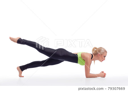 Attractive female gymnast exercising at studio 79307669