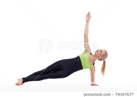 Attractive female gymnast exercising at studio 79307677
