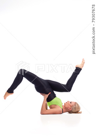 Attractive female gymnast exercising at studio 79307678