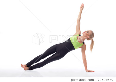Attractive female gymnast exercising at studio 79307679