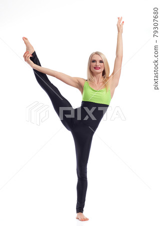 Attractive female gymnast exercising at studio 79307680