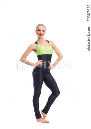 Attractive female gymnast exercising at studio 79307681