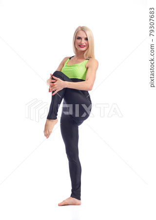 Attractive female gymnast exercising at studio 79307683