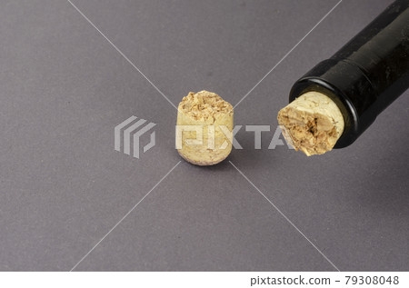 Wine bottle with broken cork on gray background. 79308048