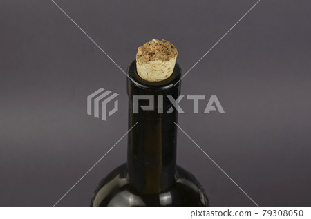 Wine bottle with broken cork on gray background. 79308050