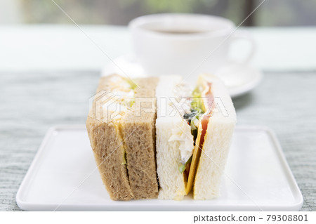 Delicious vegetable sandwiches, egg sandwiches and coffee 79308801