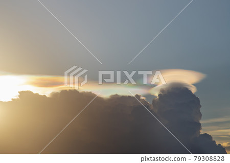 Iridescent pileus cloud. Before sunset sky above clouds with dramatic light. Beautiful blazing sunset landscape, Horizon. Iridescent pileus cloud. Before sunset sky above clouds with dramatic light. Beautiful blazing sunset landscape, Horizon. 79308828