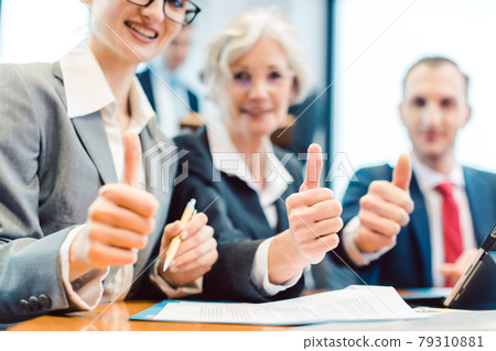 Business people showing thumbs up upon successful project Business people showing thumbs up upon successful project 79310881
