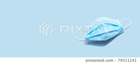 Blue surgical mask overhead view 79311241