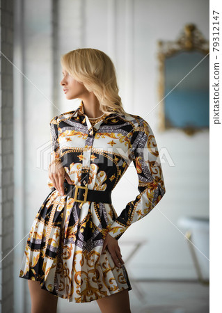 Sexy fashionable blonde in dress with belt. 79312147