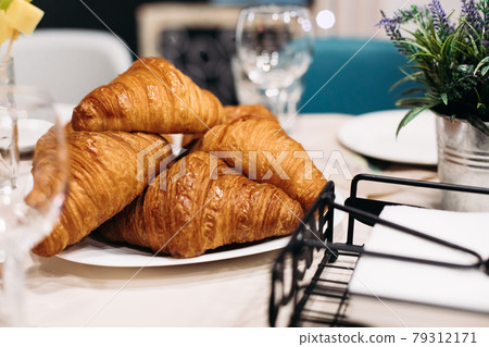 Tabletop photo of fresh crisp croissants displayed 79312171