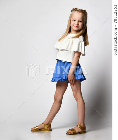 cute smiling little girl in white blouse, shorts cute smiling little girl in white blouse, shorts 79312253