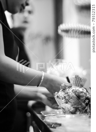staff making italian gelato ice cream sundae in modern shop 79312315