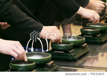 Image of up funeral of a woman's hand burning incense Image of up funeral of a woman's hand burning incense 79315847