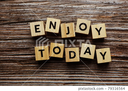 Enjoy Today alphabet letter on wooden background Enjoy Today alphabet letter on wooden background 79316564