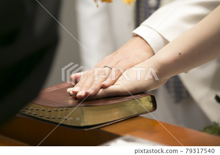 Wedding image image putting hands on the Bible 79317540