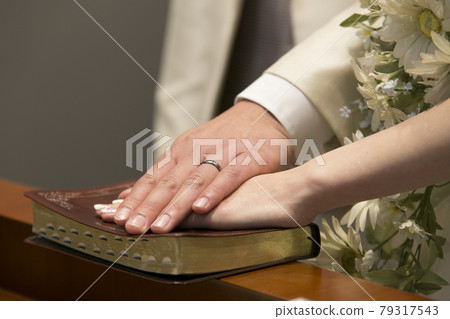 Wedding image image putting hands on the Bible 79317543