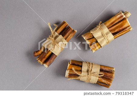 Bully sticks for dogs wrapped in brown paper and tied with twine Bully sticks for dogs wrapped in brown paper and tied with twine 79318347