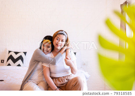 Two asian woman hugging in bedroom together,Happy and smiling,Lesbian,LGBT Two asian woman hugging in bedroom together,Happy and smiling,Lesbian,LGBT 79318585