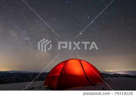 Snowy mountains, starry sky and tent 79319220