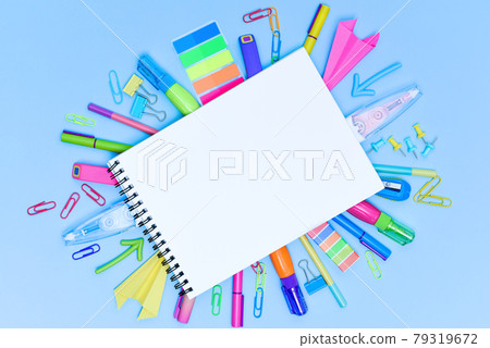 A set of multi-colored school and office stationery laid out under a blank sheet of notebook. A set of multi-colored school and office stationery laid out under a blank sheet of notebook. 79319672